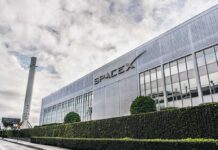 SpaceX headquarters exterior with rocket booster and hedge