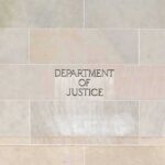 DOJ Memo Allows Top Appointees To Campaign Department of Justice building facade with engraved sign