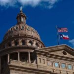 Texas State Capitol dome with U.S. and Texas flags
