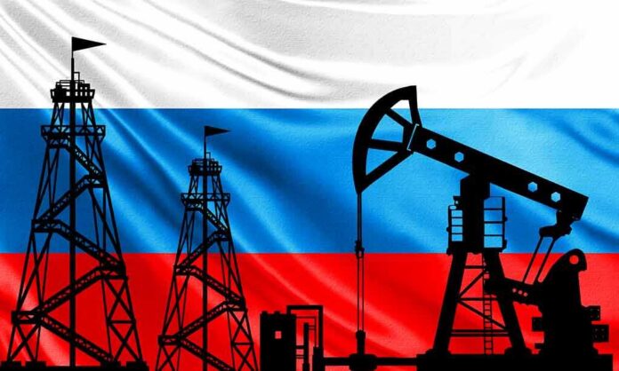 Silhouettes of oil rigs against a tricolor flag background
