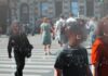 Crowd crossing a city street with digital tracking overlays
