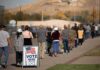 voters standing in a long line outside a polling place