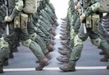 Live-Fire Chaos: Four Dead, Dozens Hurt Soldiers in green uniforms march in formation