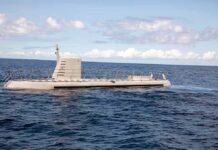 Submarine cruising on calm ocean surface