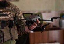 soldier holding a quadcopter drone