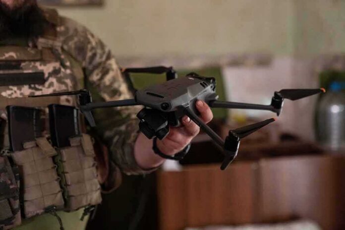 soldier holding a quadcopter drone