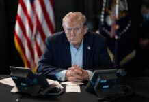 Six Billion Question Shadows The Pentagon Donald Trump seated at a table between two desk phones