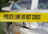 Police tape in front of a car