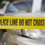 Police tape in front of a car