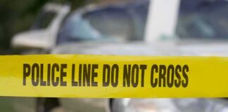 Police tape in front of a car