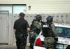 Oregon School Shooting Ends With Suspect Dead police officers in tactical gear beside patrol car